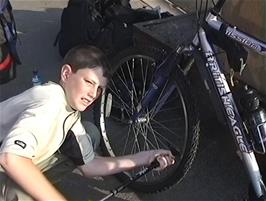 Dominic pumps his tyres at Euston station, London